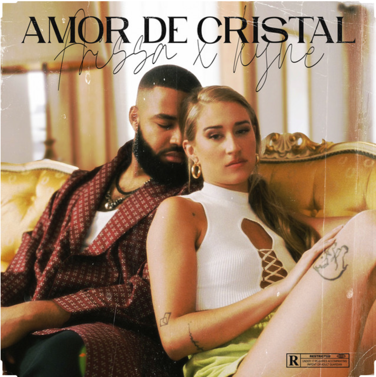 Kyne and Aissa Aslani posing together on vintage sofa for Amor de Cristal cover artwork