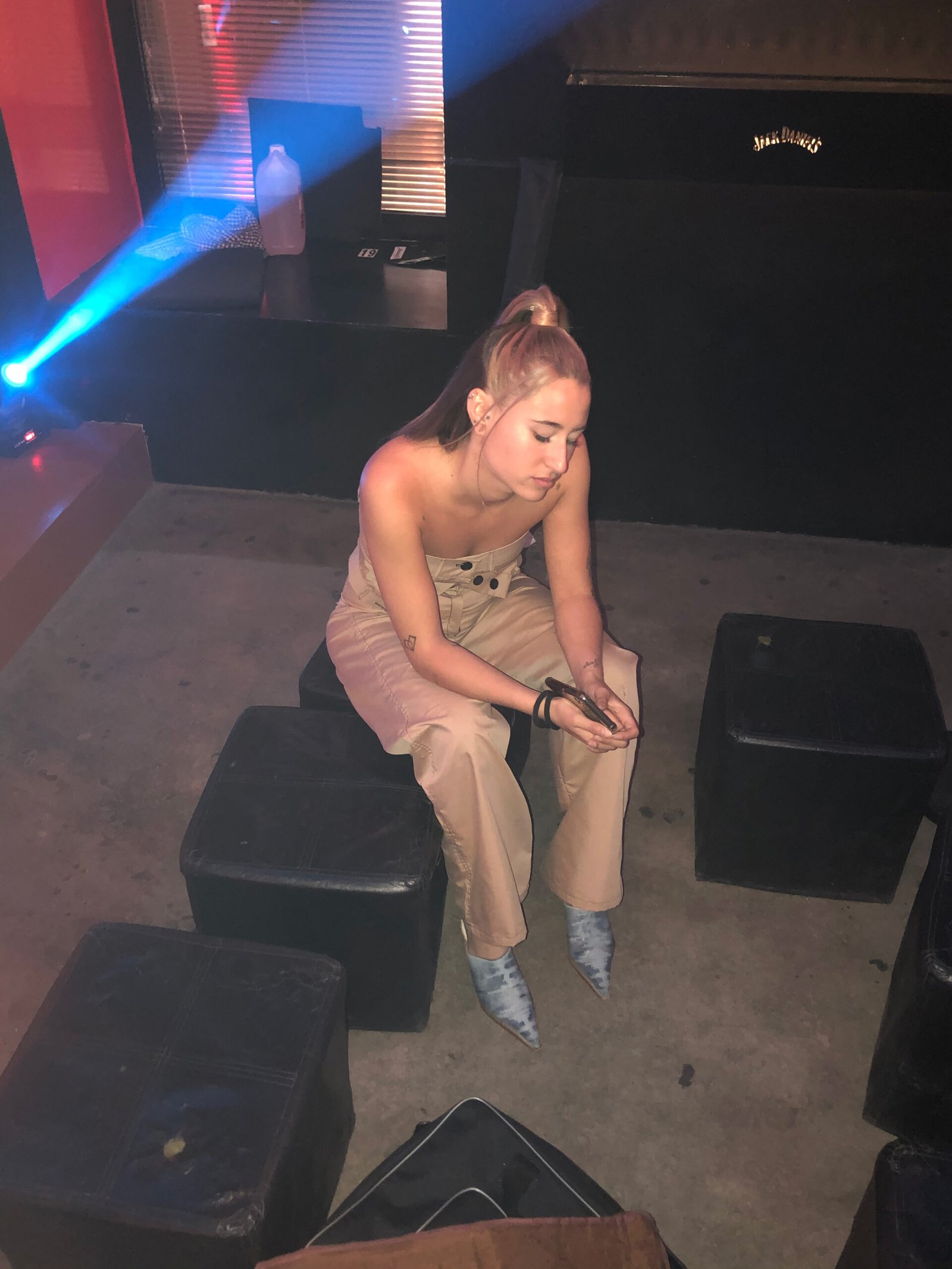 Kyne backstage before live performance wearing custom beige stage outfit and pointed boots